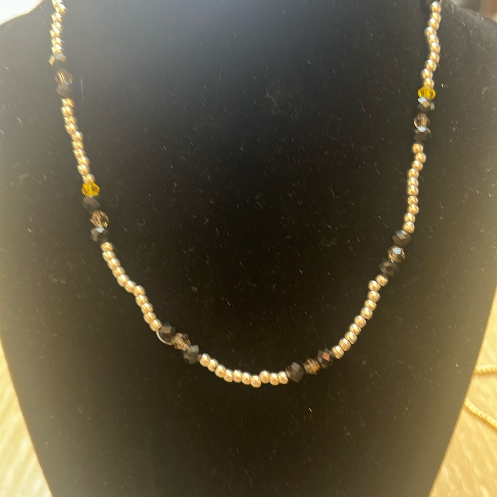 Handmade 16” silver colored, black and yellow glass bead necklace.